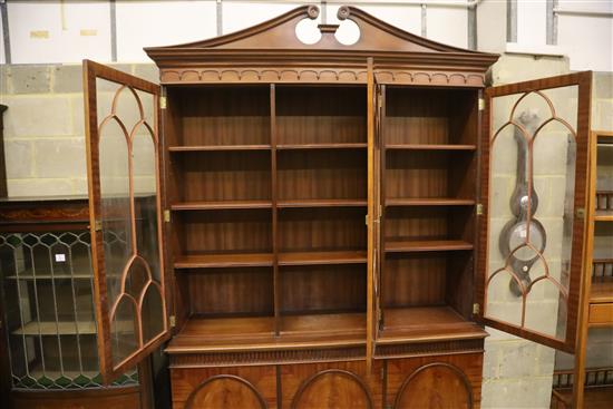 Charles Barr Furniture, A Sheraton-style mahogany library bookcase with swan-neck pediment, W.154cm, D.48cm, H.230cm